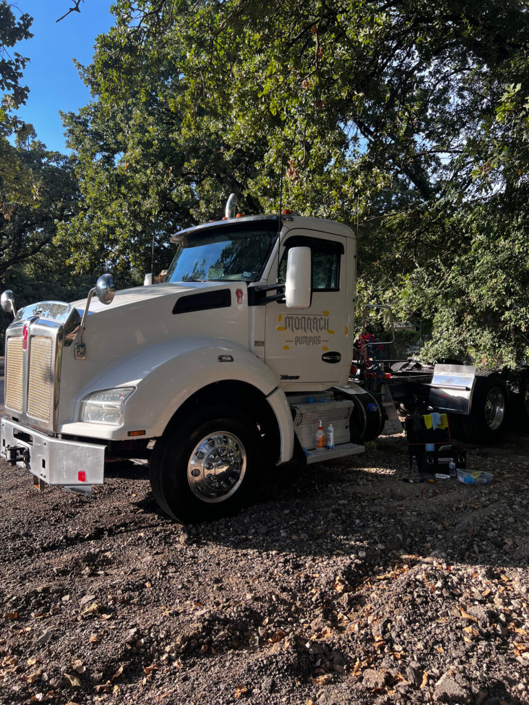 White Kenworth semi-truck with company name, logo, and USDOT number graphics installed on the cab.